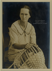 Woman weaving an oak basket